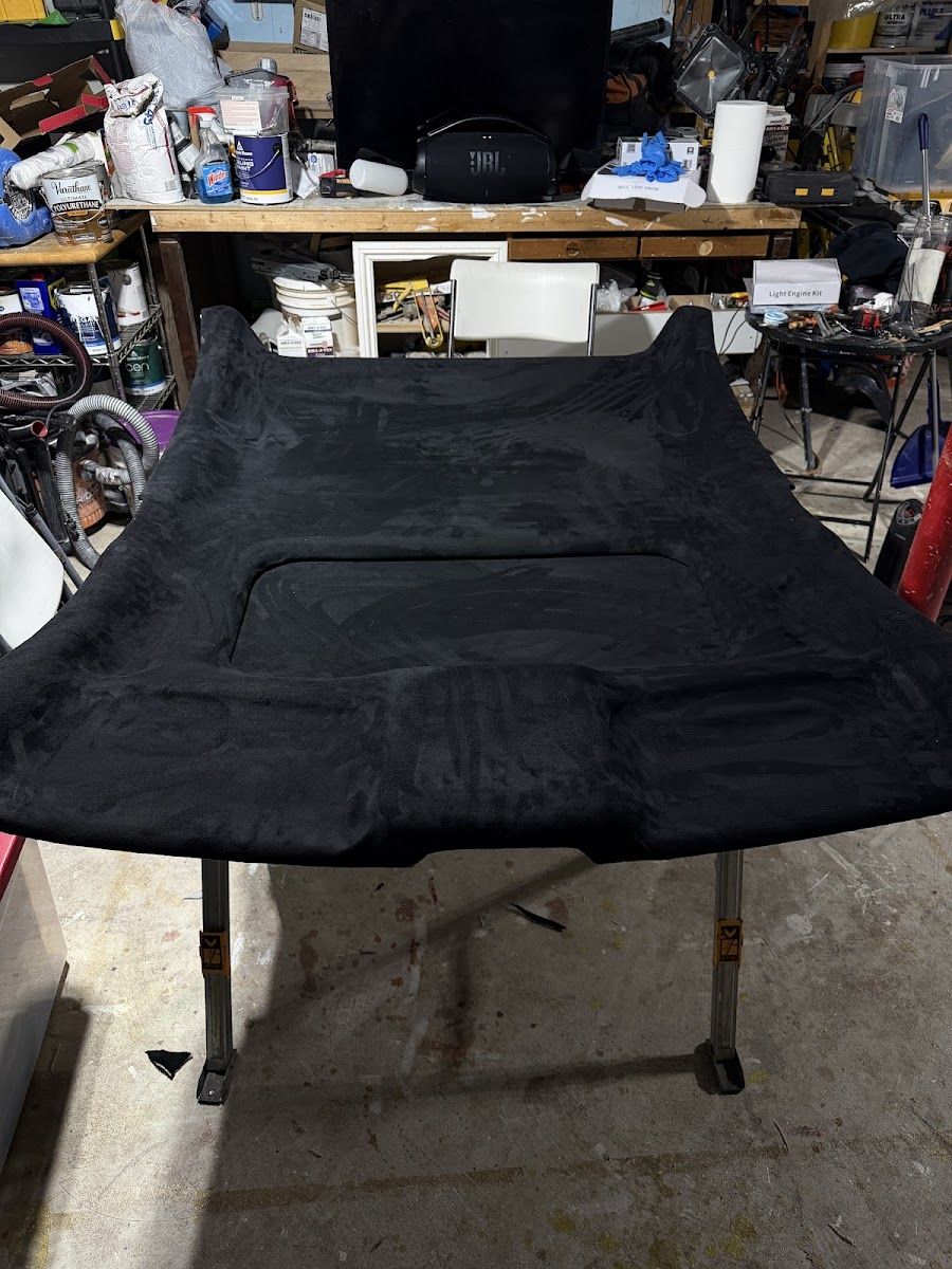 Headliner panel laid flat on the workbench in the Danbury shop