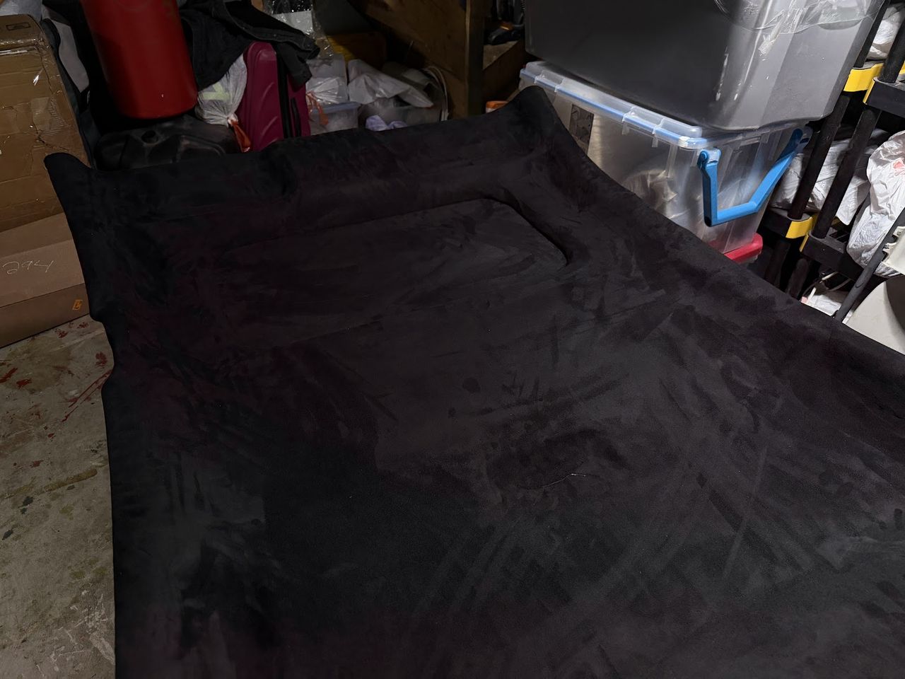Headliner panel being wrapped in fabric on the workbench